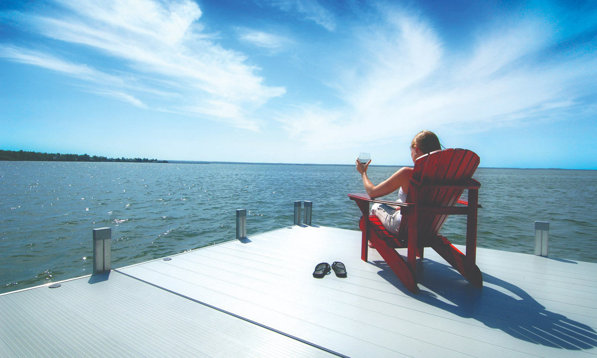 woman sitting in beach chair on dock